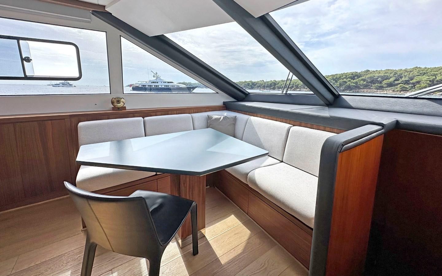 a room with a table and chairs aboard LORCA Yacht for Sale