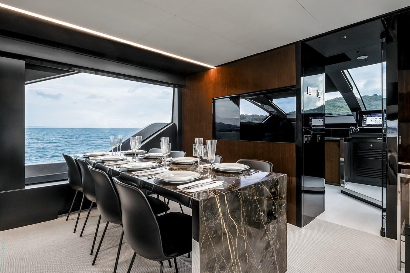a dining table in a room aboard RIVA 82 DIVA Yacht for Sale