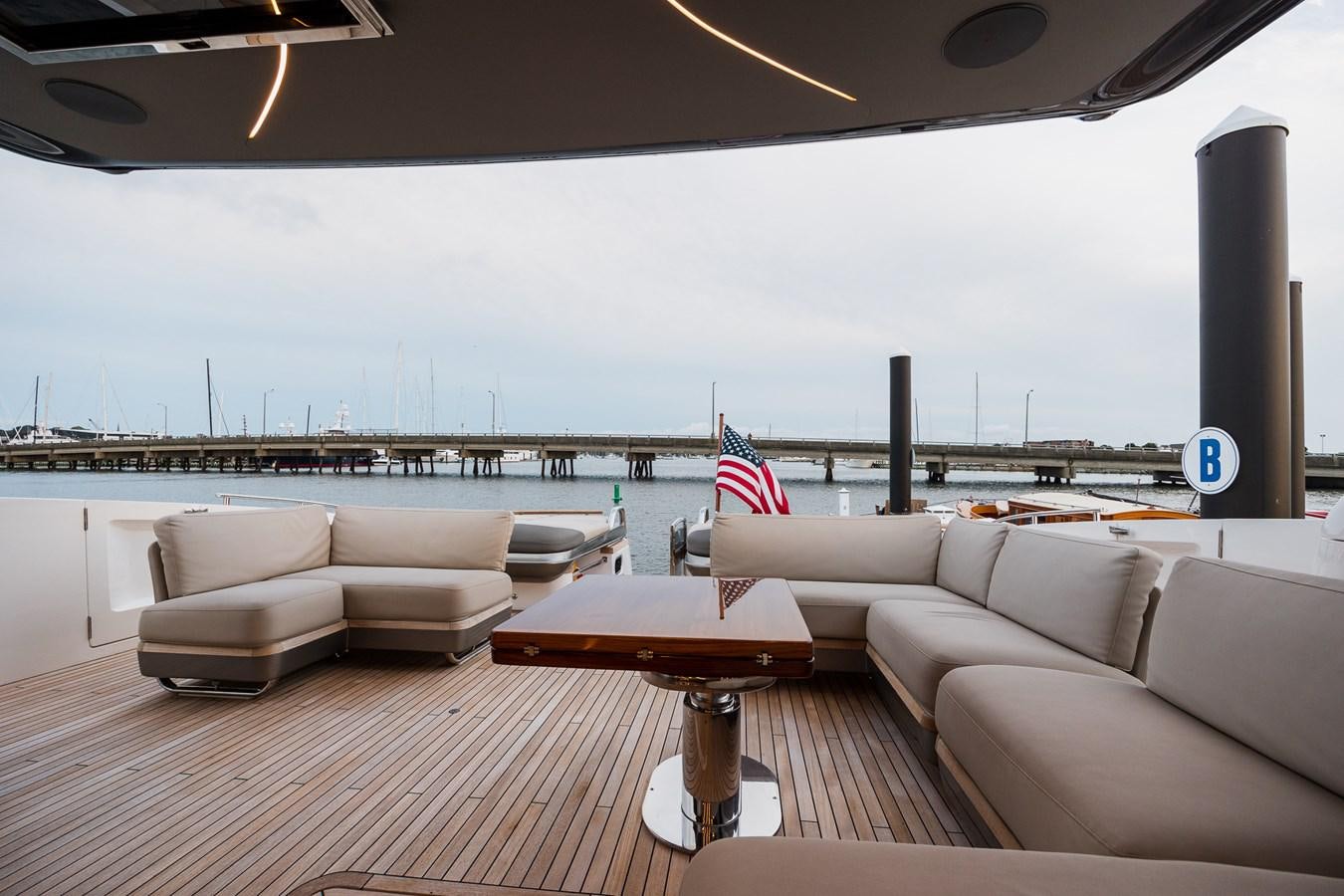 a room with couches and a table and a flag aboard SPINDRIFT Yacht for Sale