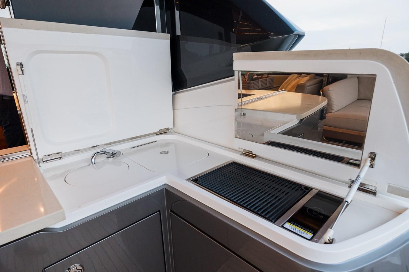 a white sink with a black faucet and a box on it aboard SPINDRIFT Yacht for Sale