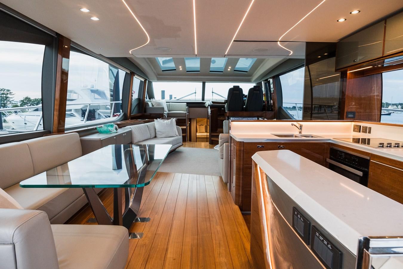 inside of a vehicle with tables and chairs and a large window aboard SPINDRIFT Yacht for Sale