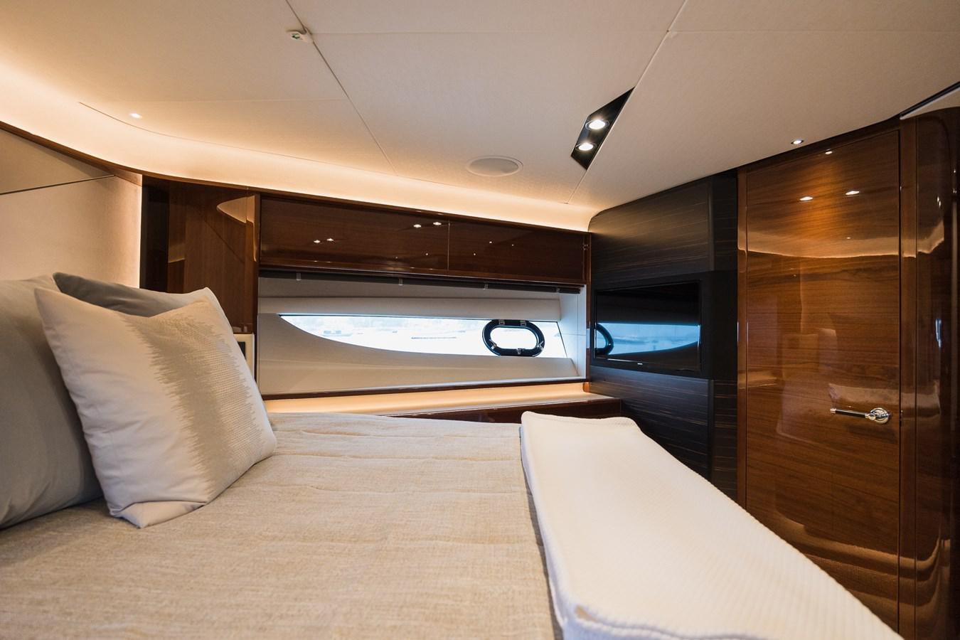 a bed with a white bed and a wooden cabinet aboard SPINDRIFT Yacht for Sale