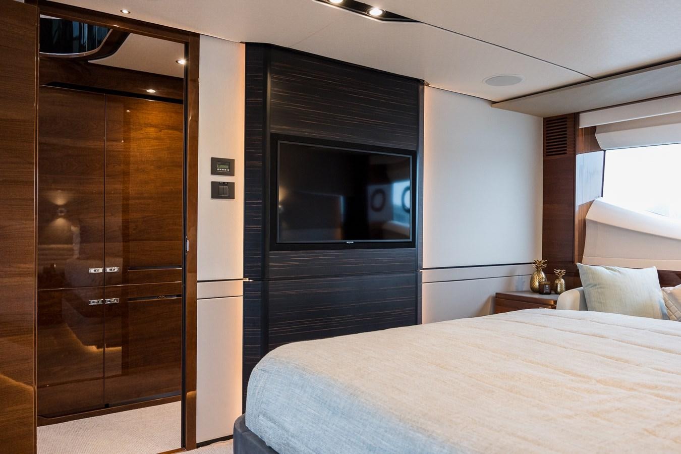 a bedroom with a bed and a television aboard SPINDRIFT Yacht for Sale