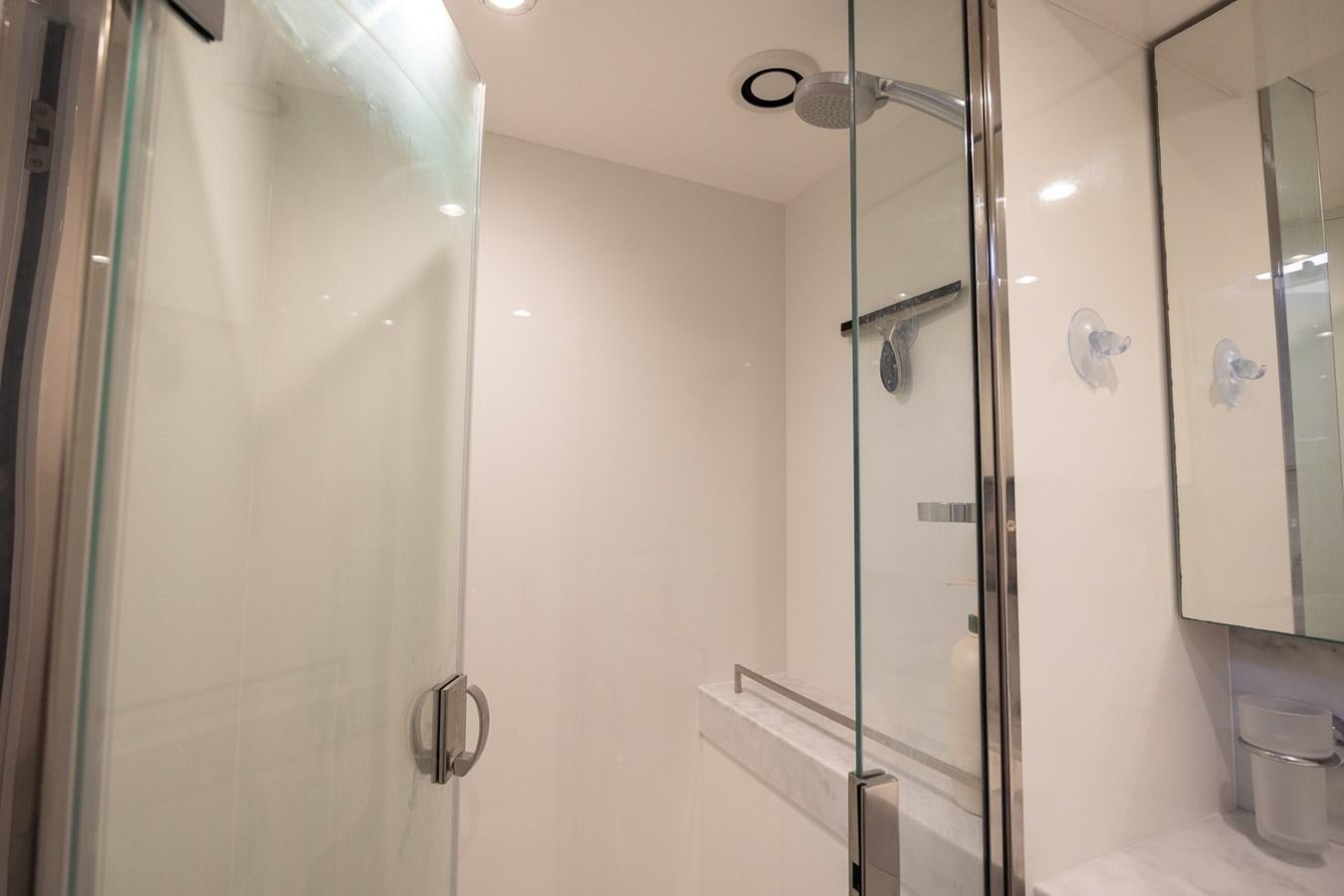 a bathroom with a glass shower aboard SPINDRIFT Yacht for Sale