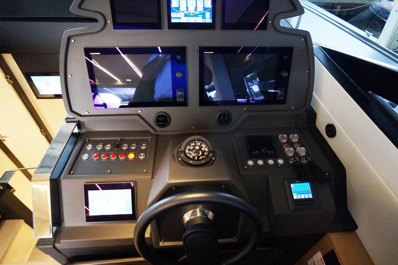 a car with a screen and buttons aboard THE OFFICE Yacht for Sale