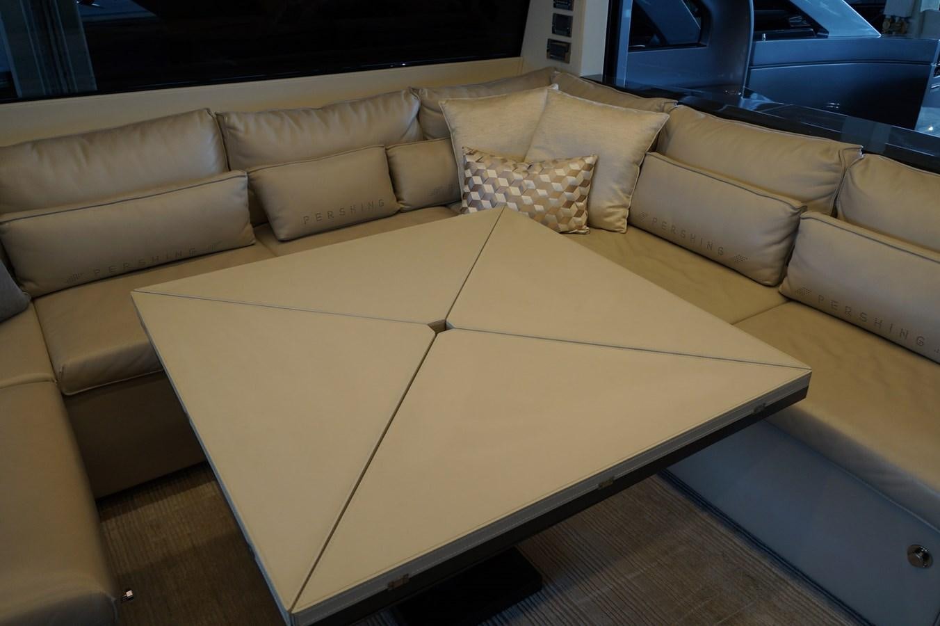 a couch with a coffee table aboard THE OFFICE Yacht for Sale