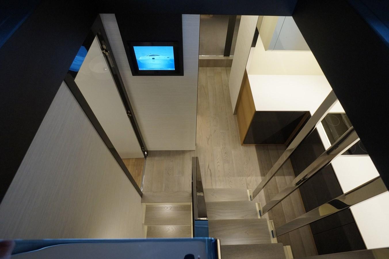 a staircase with a tv on the side aboard THE OFFICE Yacht for Sale