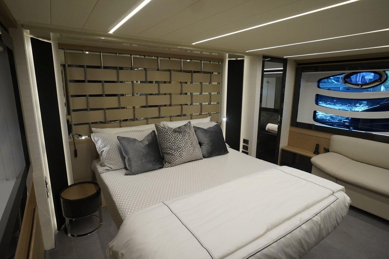 a bed with a white bed spread aboard THE OFFICE Yacht for Sale