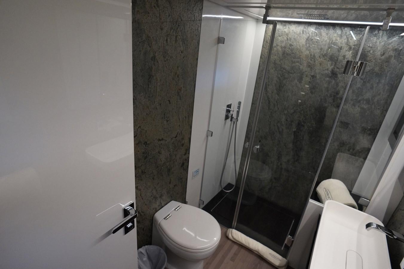 a bathroom with a glass shower aboard THE OFFICE Yacht for Sale