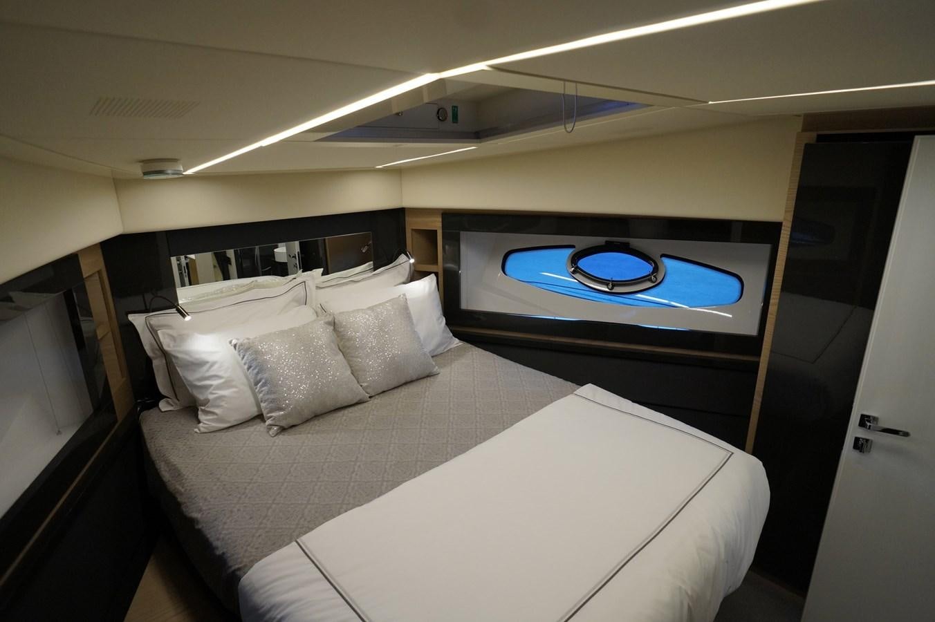 a bed with a white bed spread aboard THE OFFICE Yacht for Sale