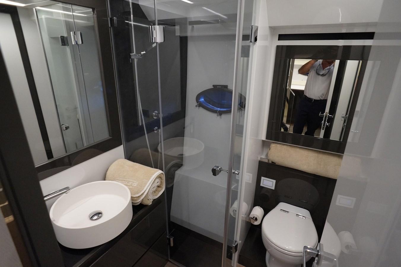 a bathroom with a glass shower aboard THE OFFICE Yacht for Sale