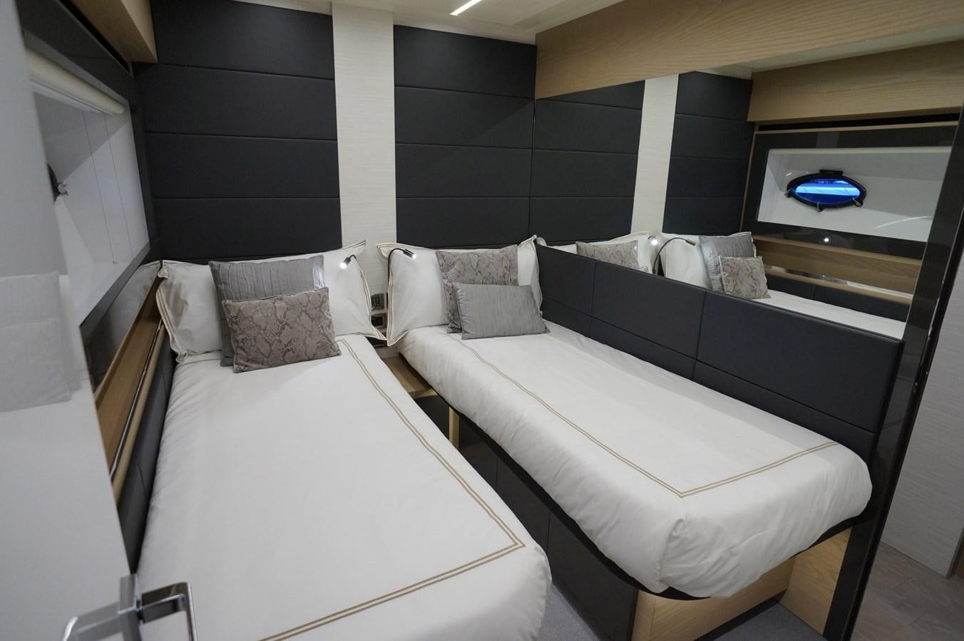 a room with beds and a mirror aboard THE OFFICE Yacht for Sale