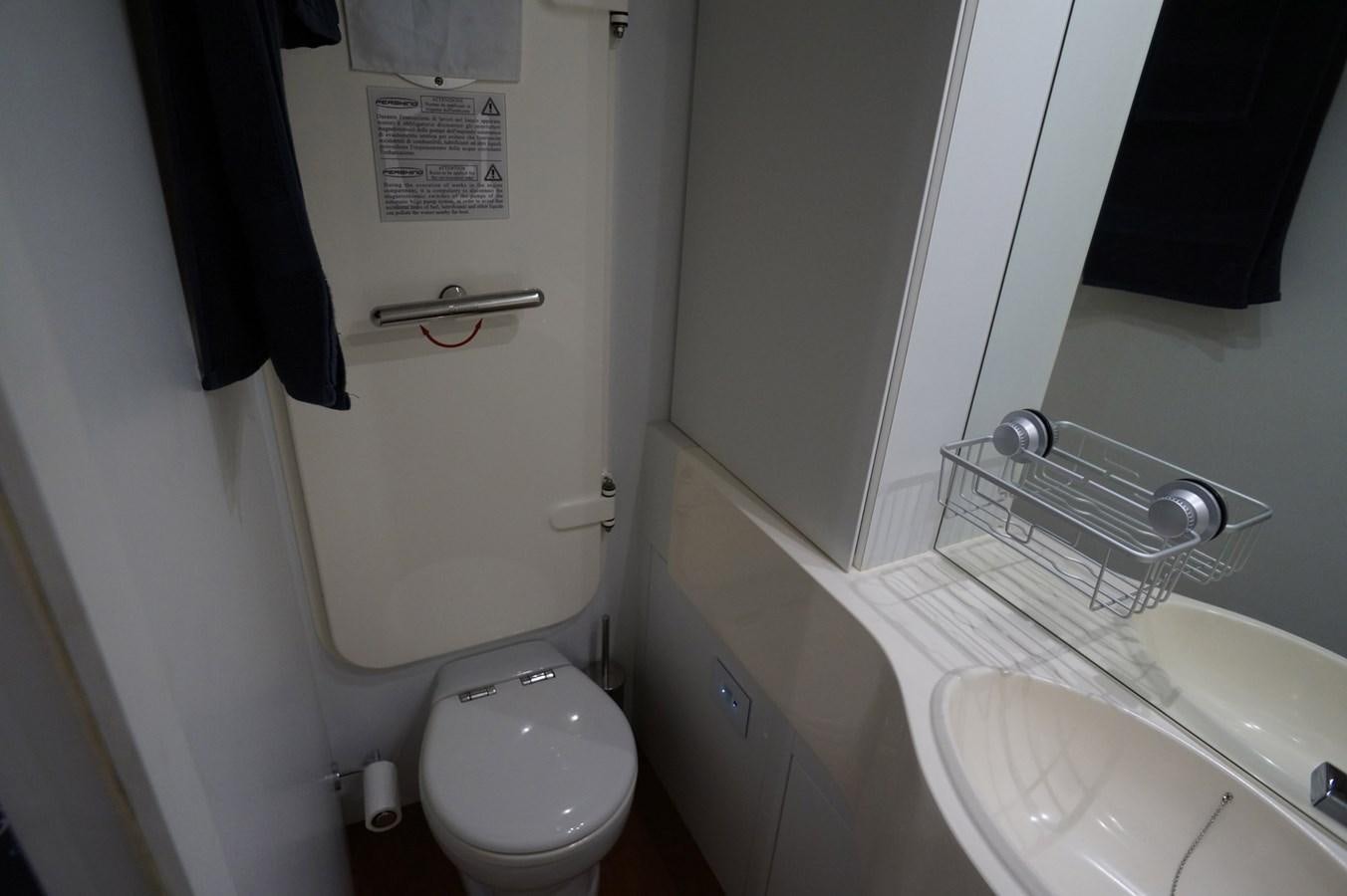 a toilet and sink in a bathroom aboard THE OFFICE Yacht for Sale
