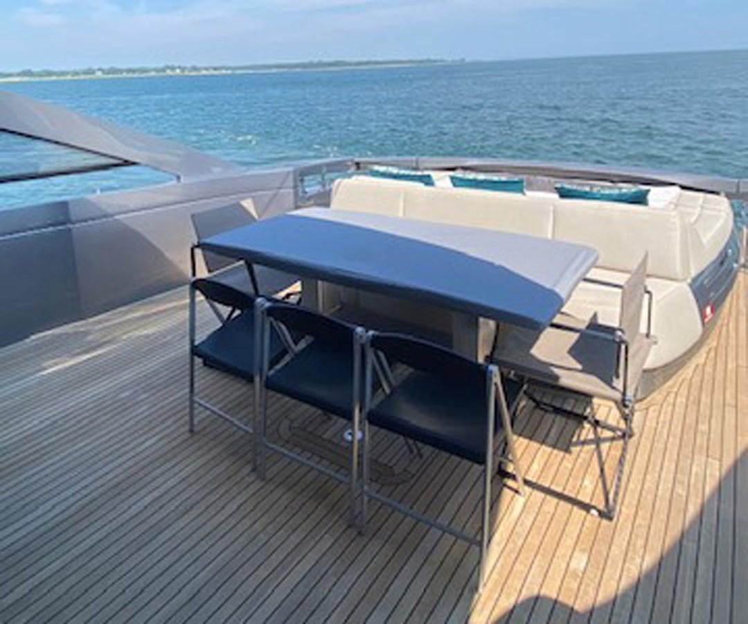 a table and chairs on a deck aboard THE OFFICE Yacht for Sale