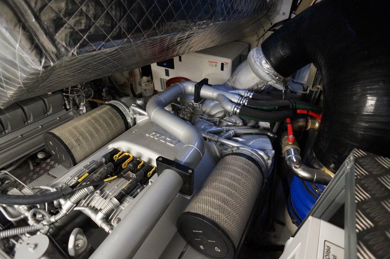 a car engine with a glove on aboard THE OFFICE Yacht for Sale
