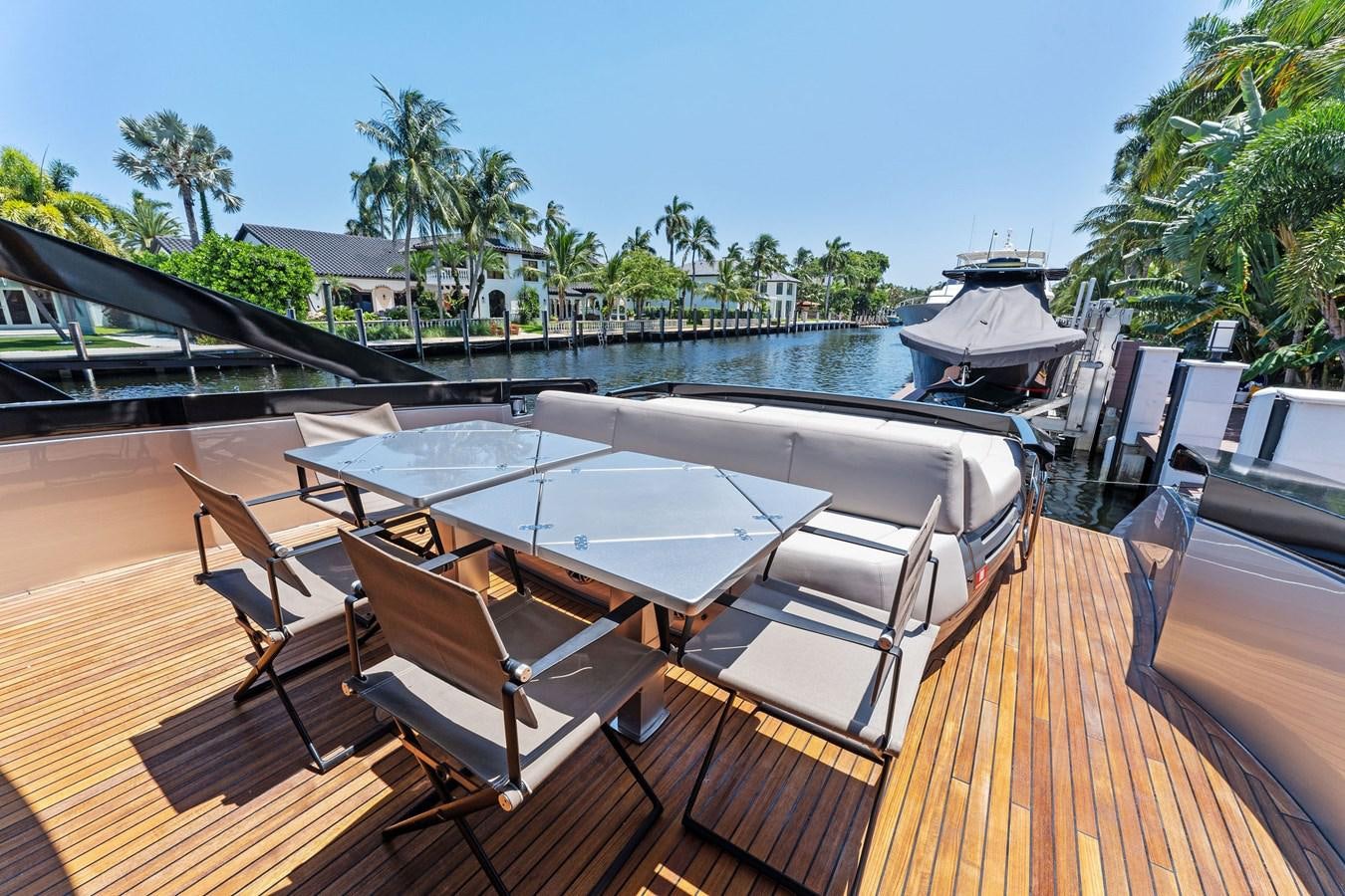 a deck with a deck and chairs on it aboard LIQUID Yacht for Sale