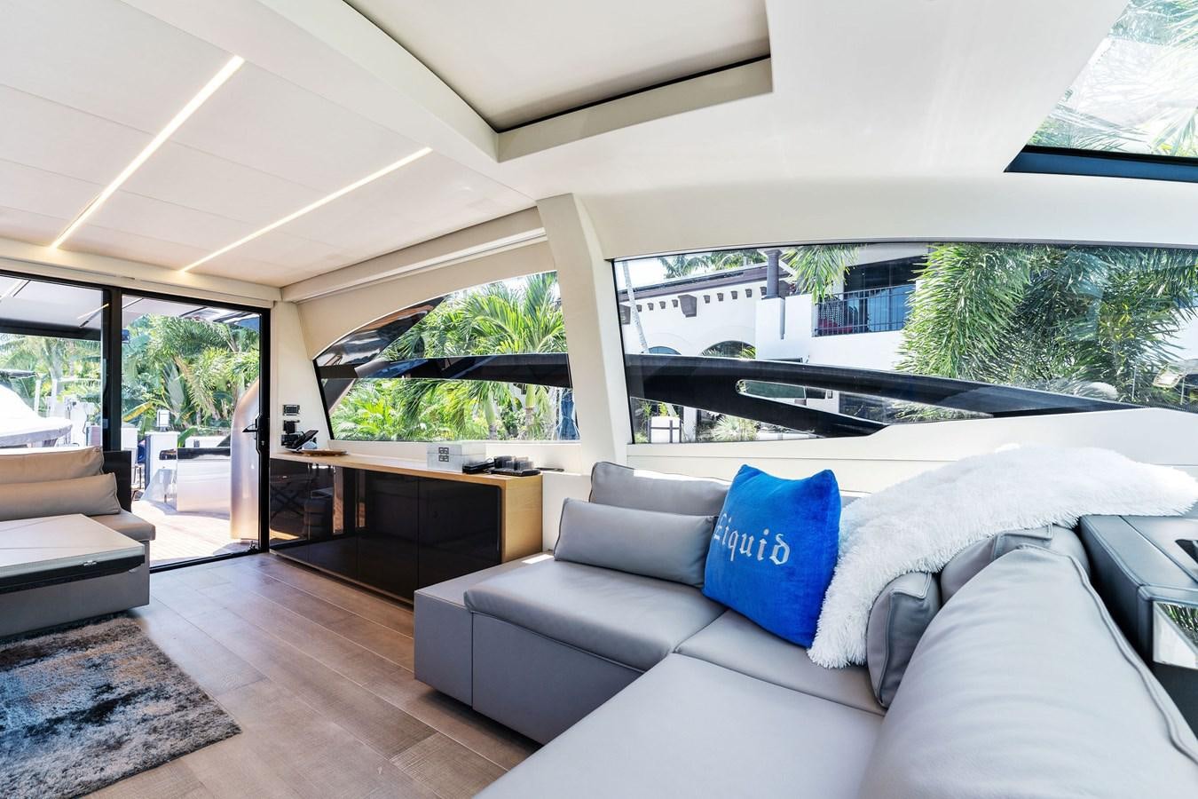 a living room with a large window aboard LIQUID Yacht for Sale