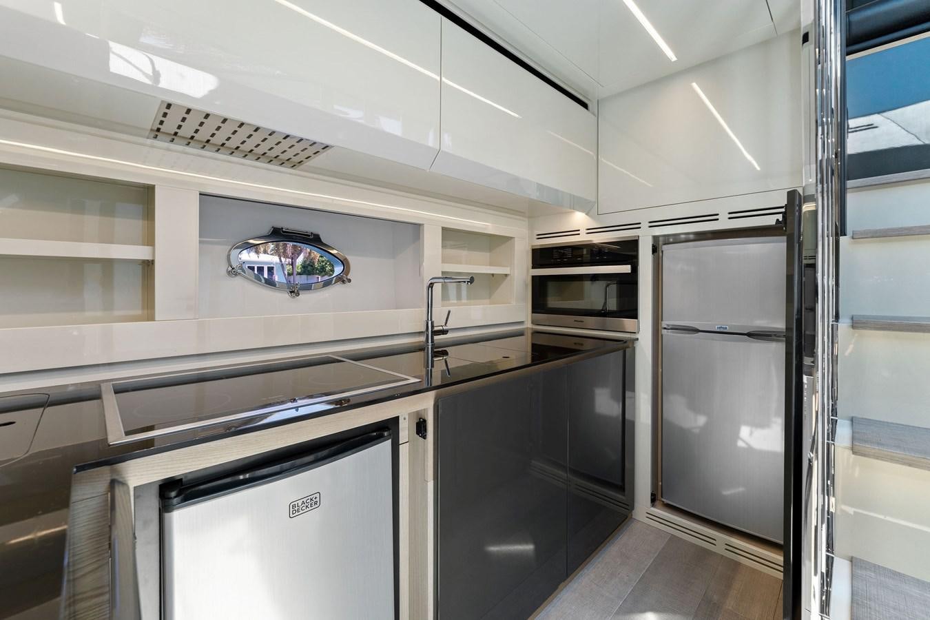 a kitchen with a large mirror aboard LIQUID Yacht for Sale