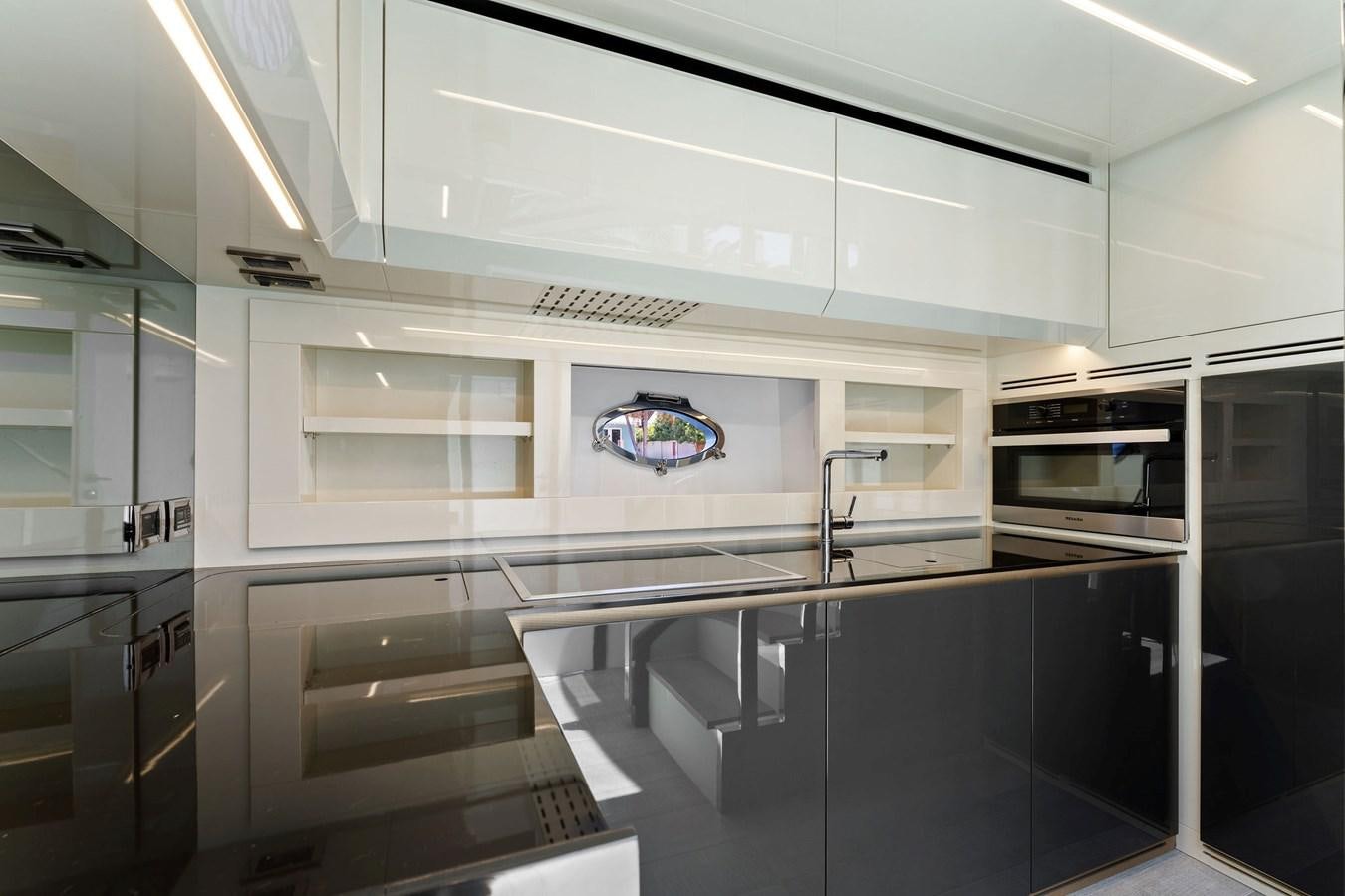 a kitchen with a large glass window aboard LIQUID Yacht for Sale