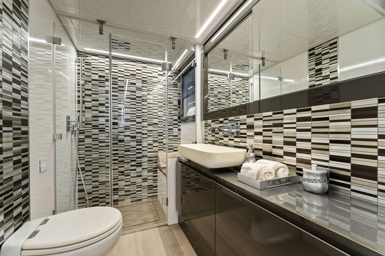 a bathroom with a glass shower aboard LIQUID Yacht for Sale