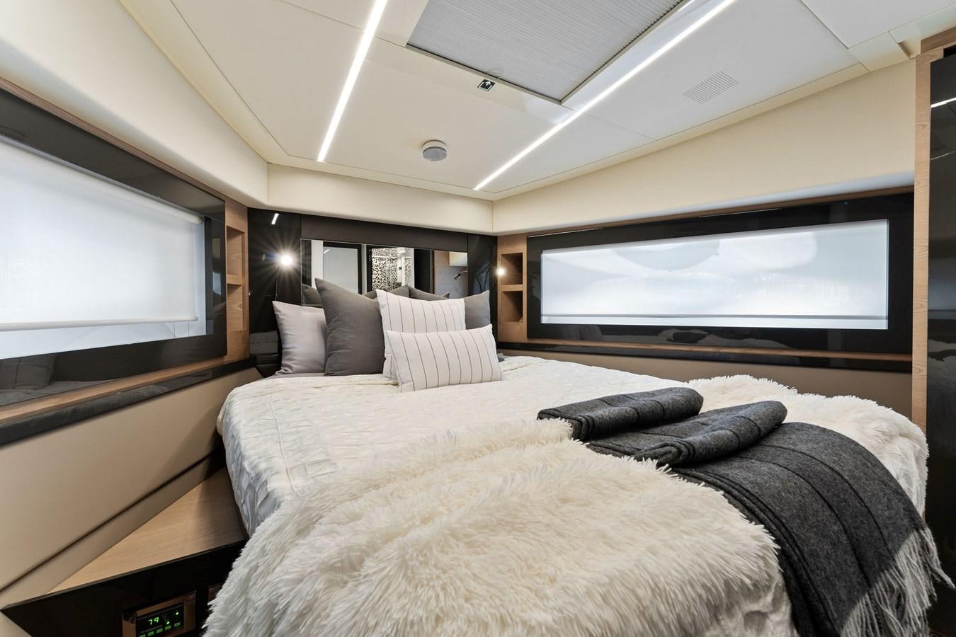 a bedroom with a large bed aboard LIQUID Yacht for Sale