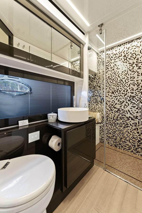 a bathroom with a sink and a toilet aboard LIQUID Yacht for Sale