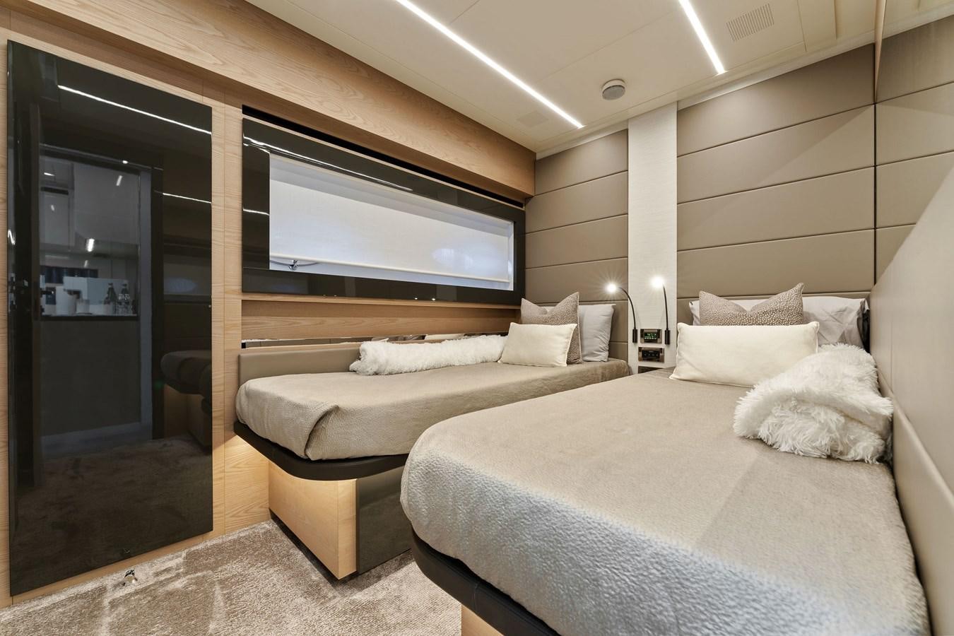 a room with two beds aboard LIQUID Yacht for Sale