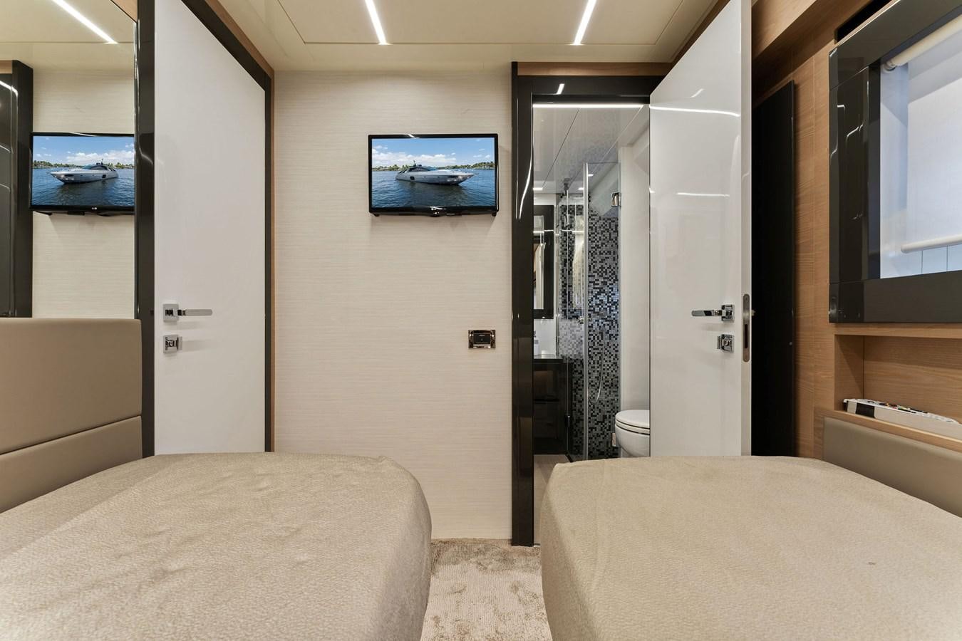 a room with a bed and a television aboard LIQUID Yacht for Sale