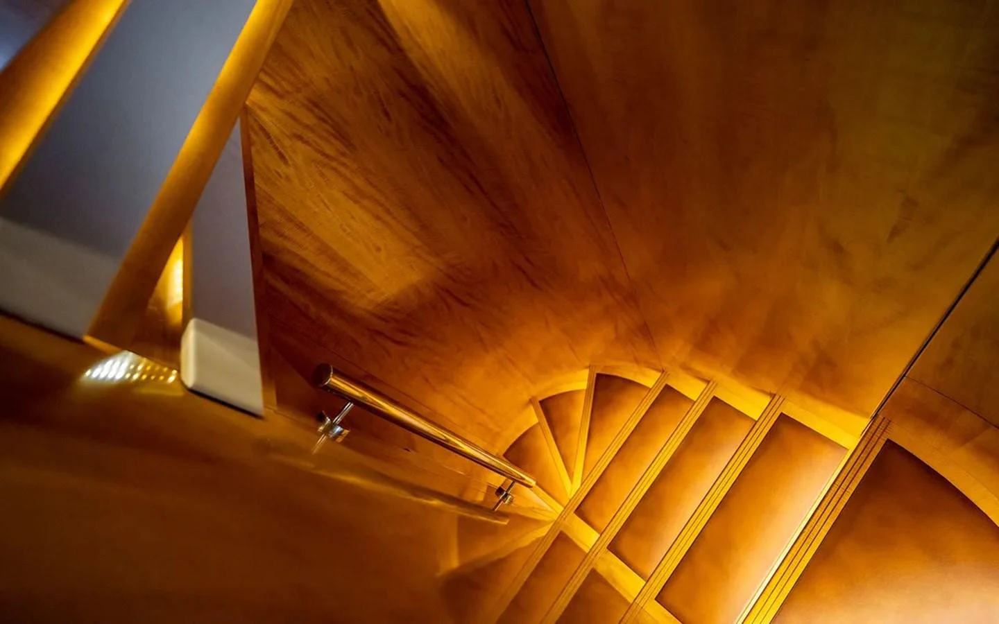 a wooden staircase with a railing aboard UNICORN Yacht for Sale