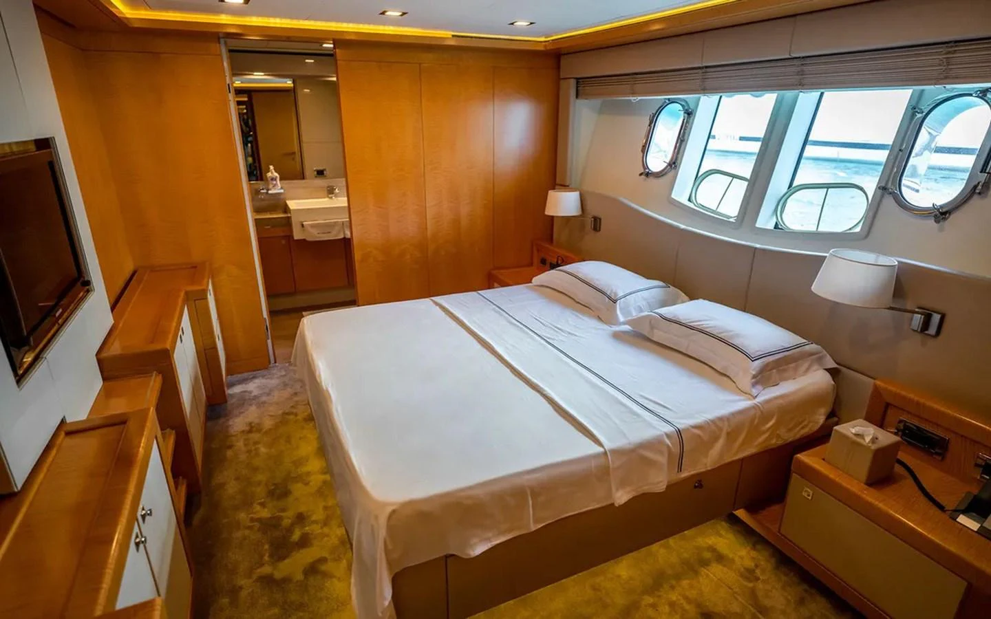 a bedroom with a bed and a television aboard UNICORN Yacht for Sale