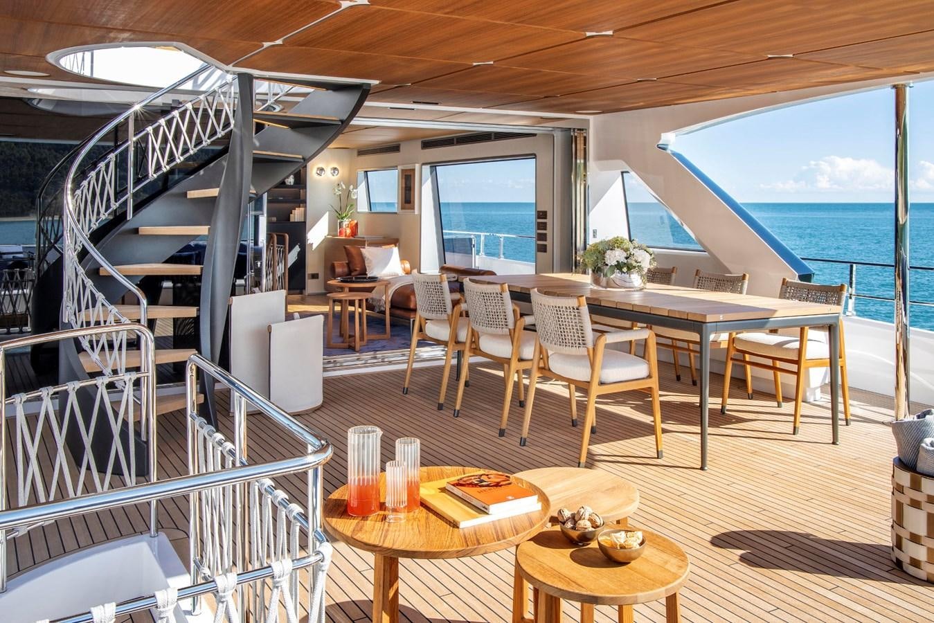 a room with tables and chairs aboard NAVETTA 30/20 Yacht for Sale