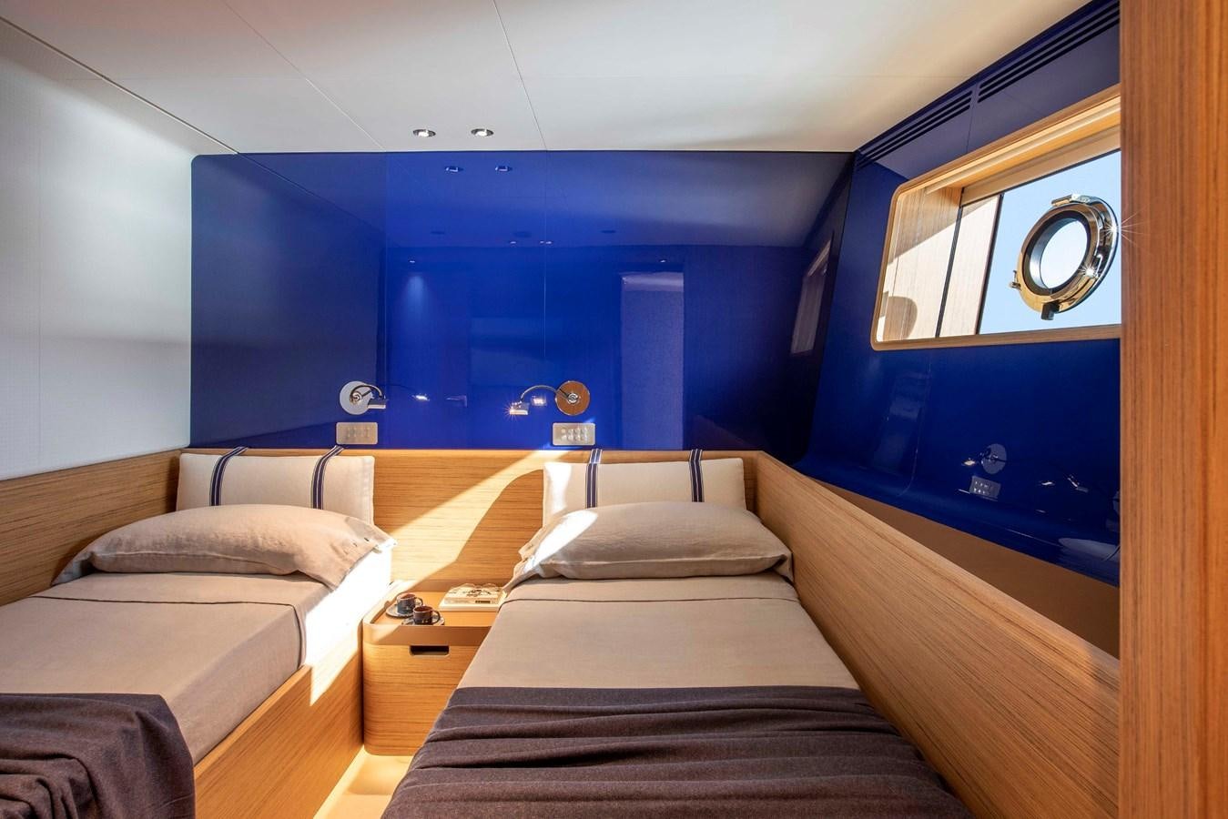 a room with beds and a mirror aboard NAVETTA 30/20 Yacht for Sale