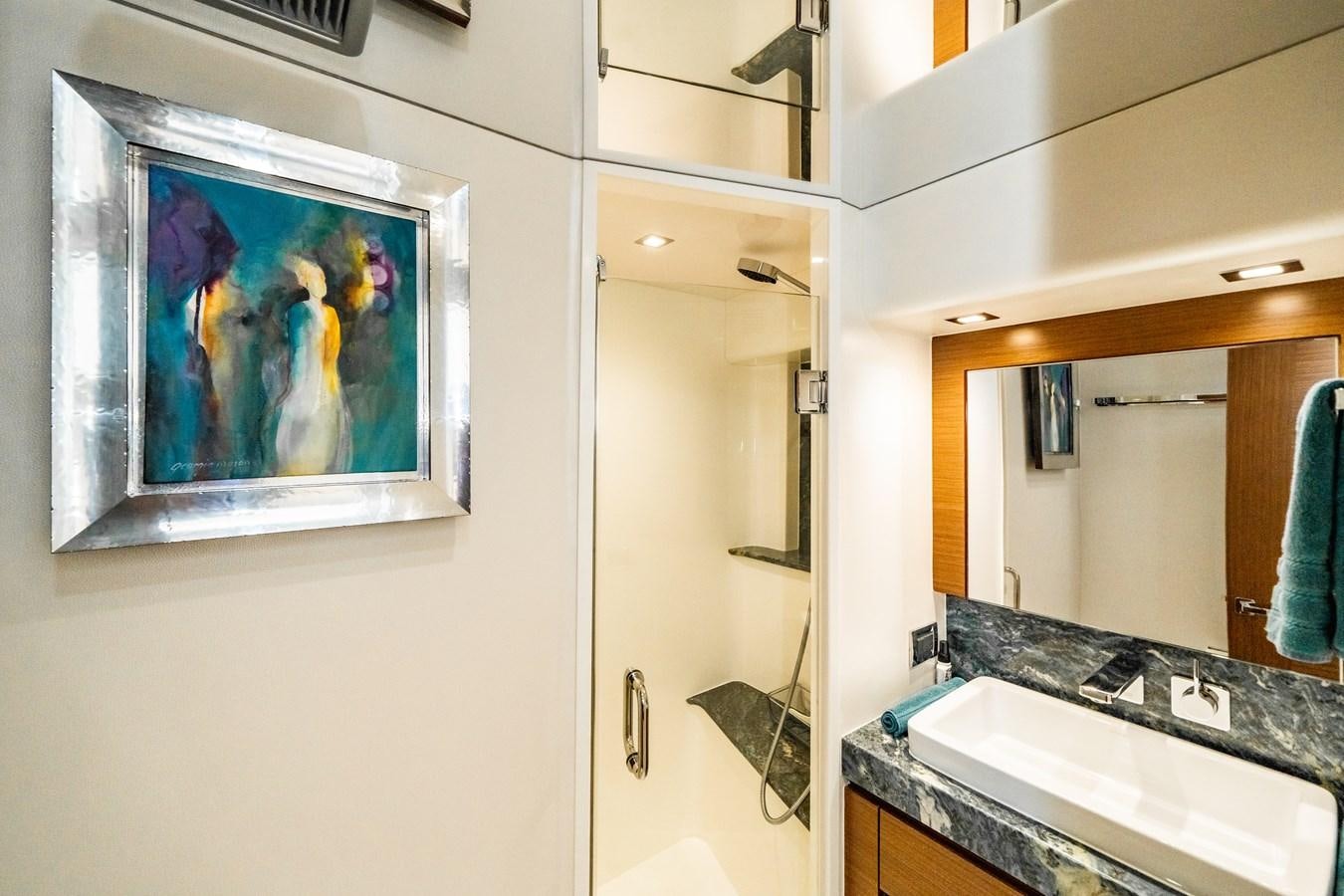 a bathroom with a large painting aboard 2017 HATTERAS M75 K SEA Yacht for Sale
