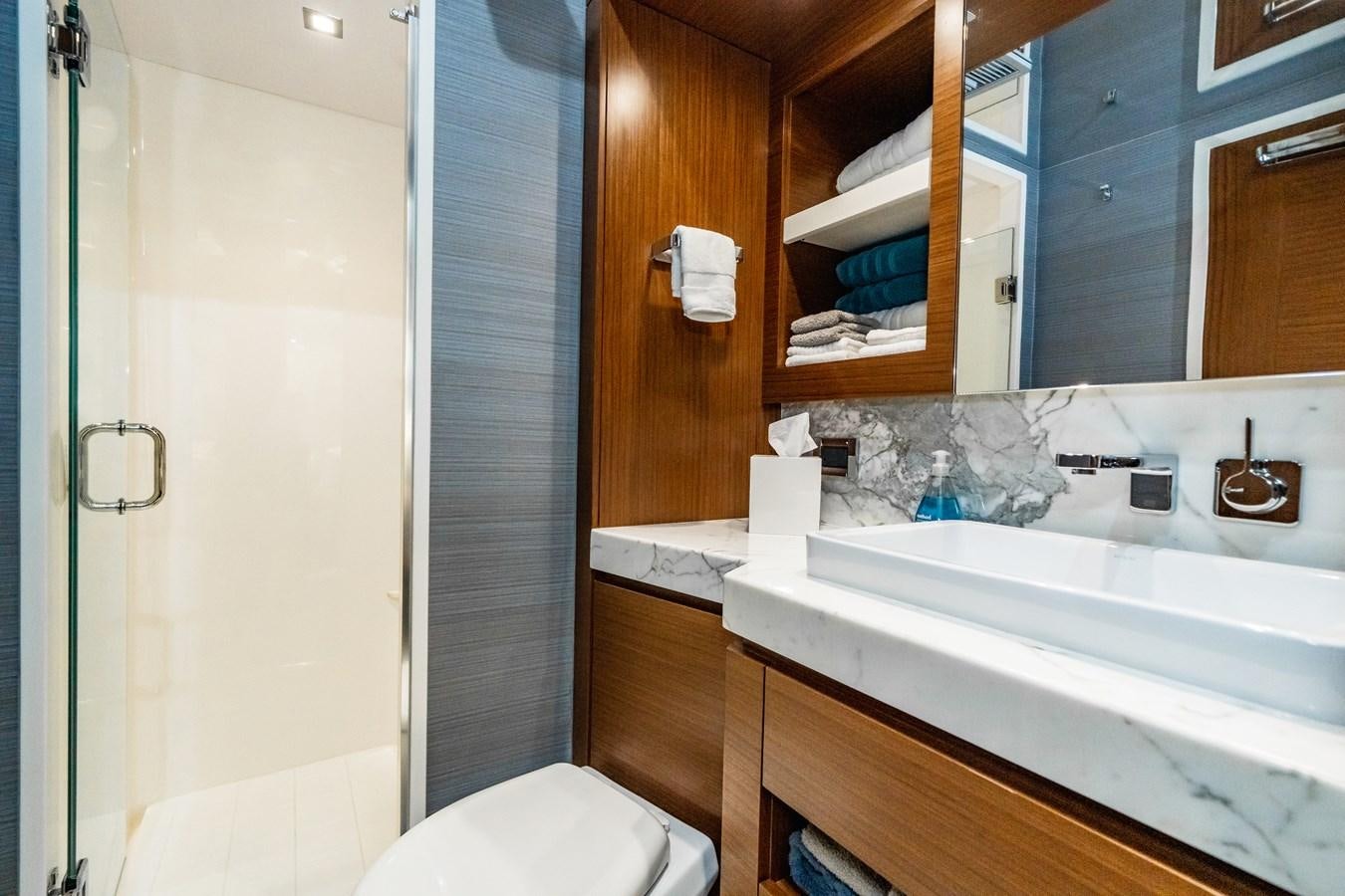 a bathroom with a sink and a toilet aboard 2017 HATTERAS M75 K SEA Yacht for Sale