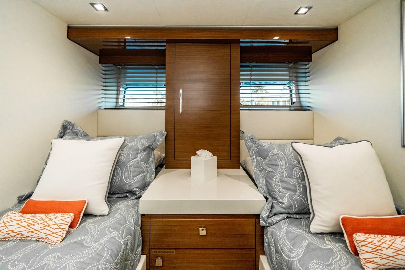 a room with a bed and a dresser aboard 2017 HATTERAS M75 K SEA Yacht for Sale