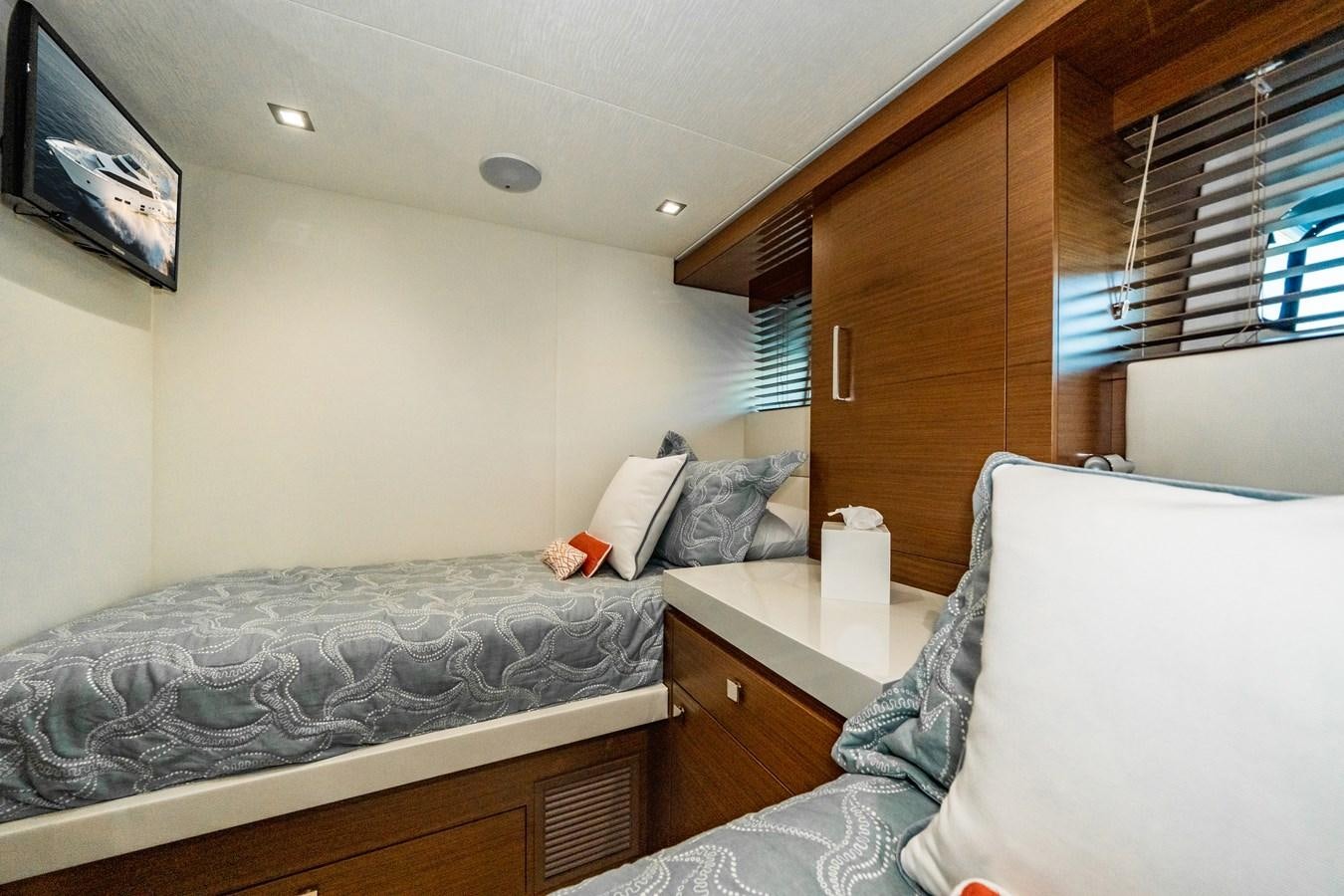 a bedroom with two beds aboard 2017 HATTERAS M75 K SEA Yacht for Sale