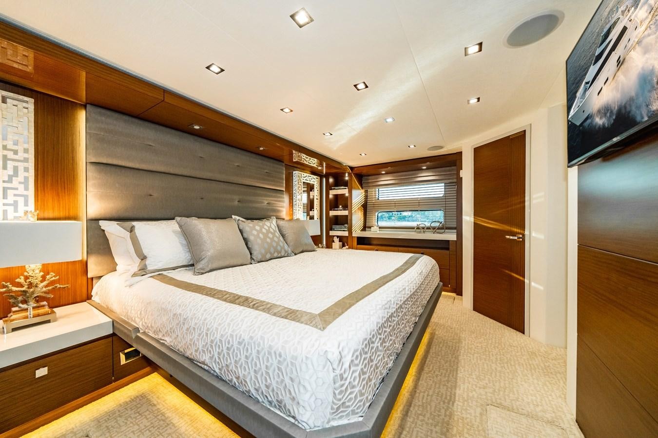 a large bedroom with a large bed aboard 2017 HATTERAS M75 K SEA Yacht for Sale