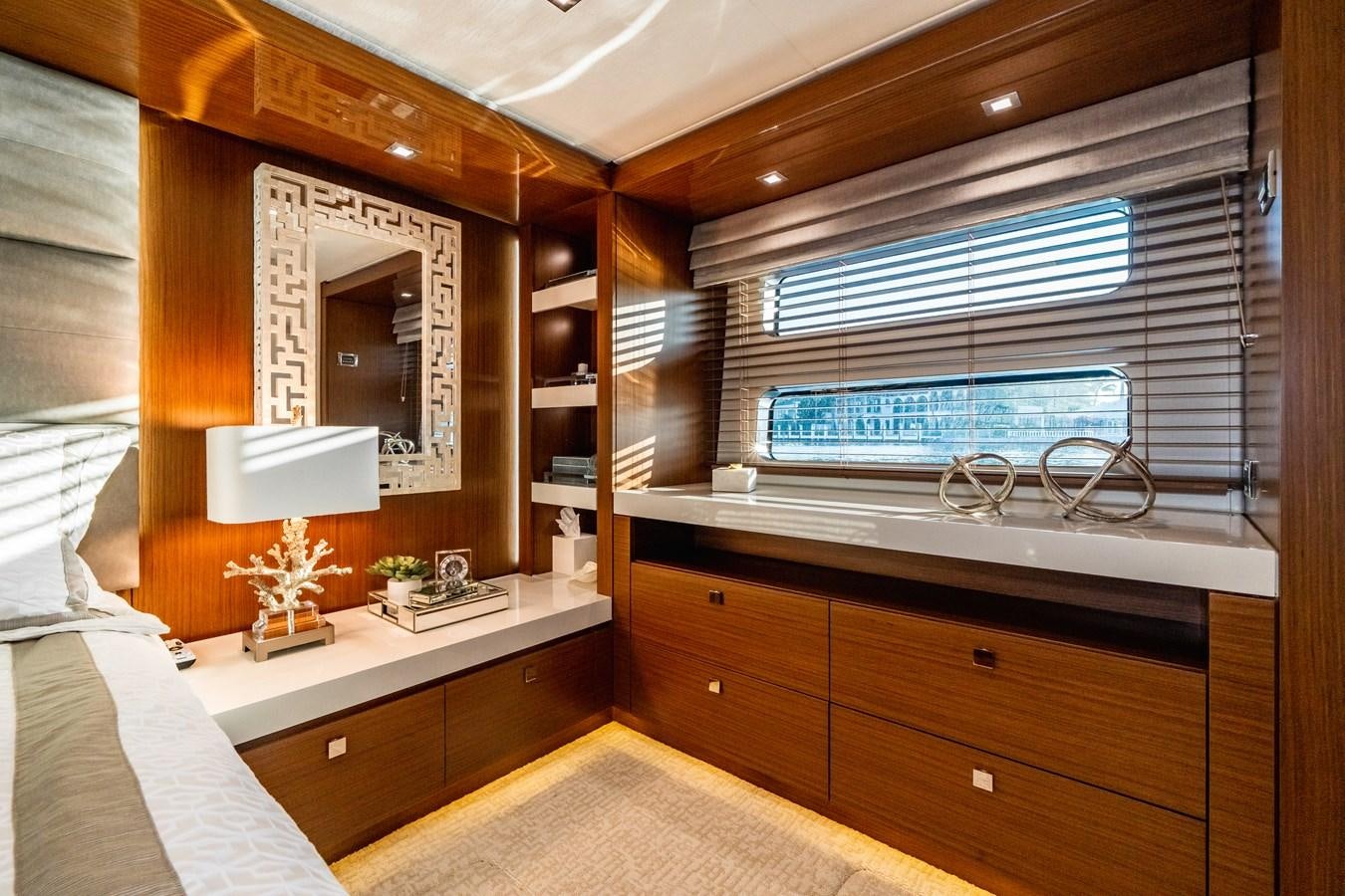 a room with a bed and a window aboard 2017 HATTERAS M75 K SEA Yacht for Sale