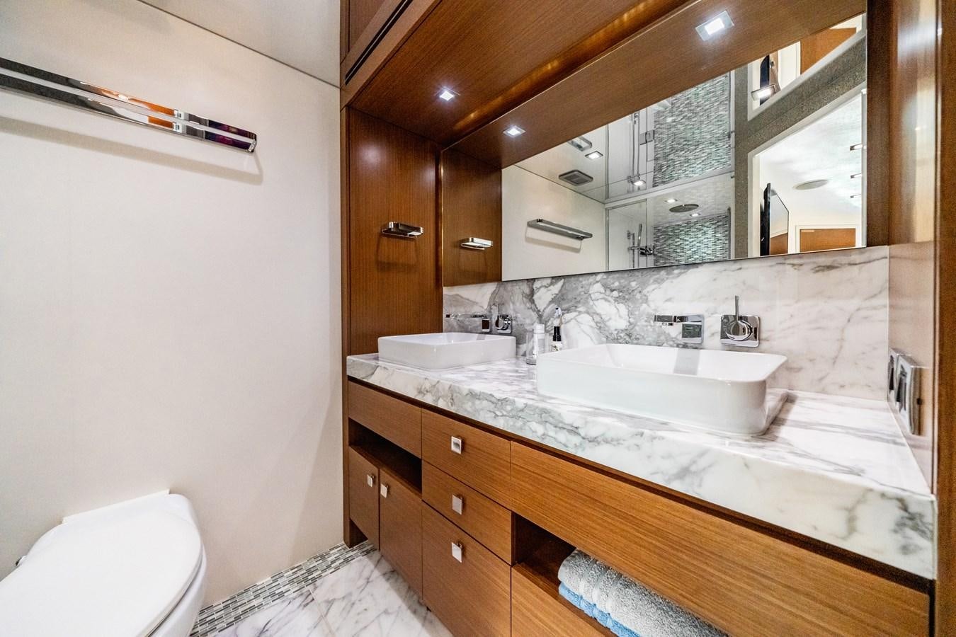 a bathroom with a large mirror aboard 2017 HATTERAS M75 K SEA Yacht for Sale