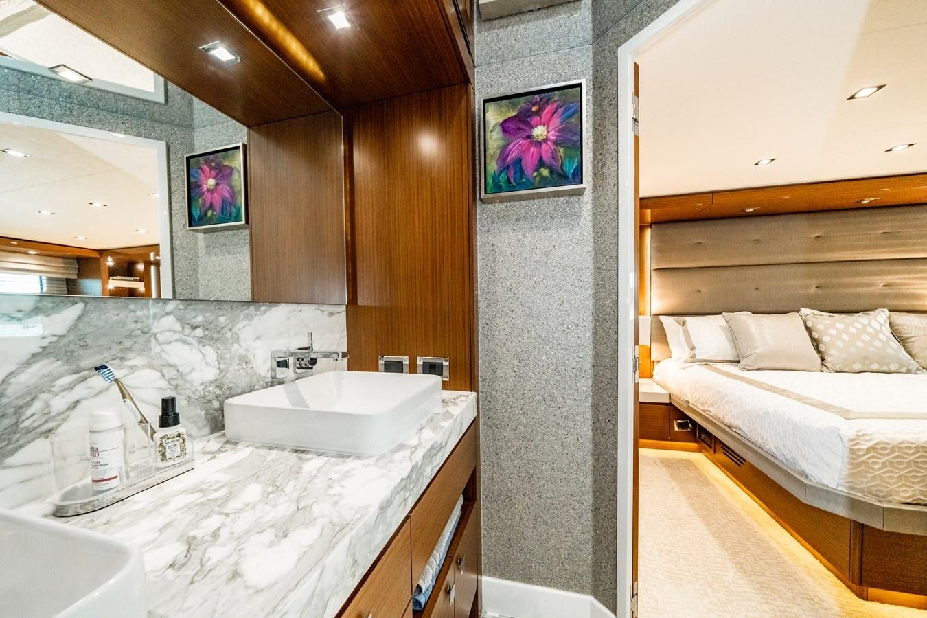 a bathroom with a sink and a bed aboard 2017 HATTERAS M75 K SEA Yacht for Sale