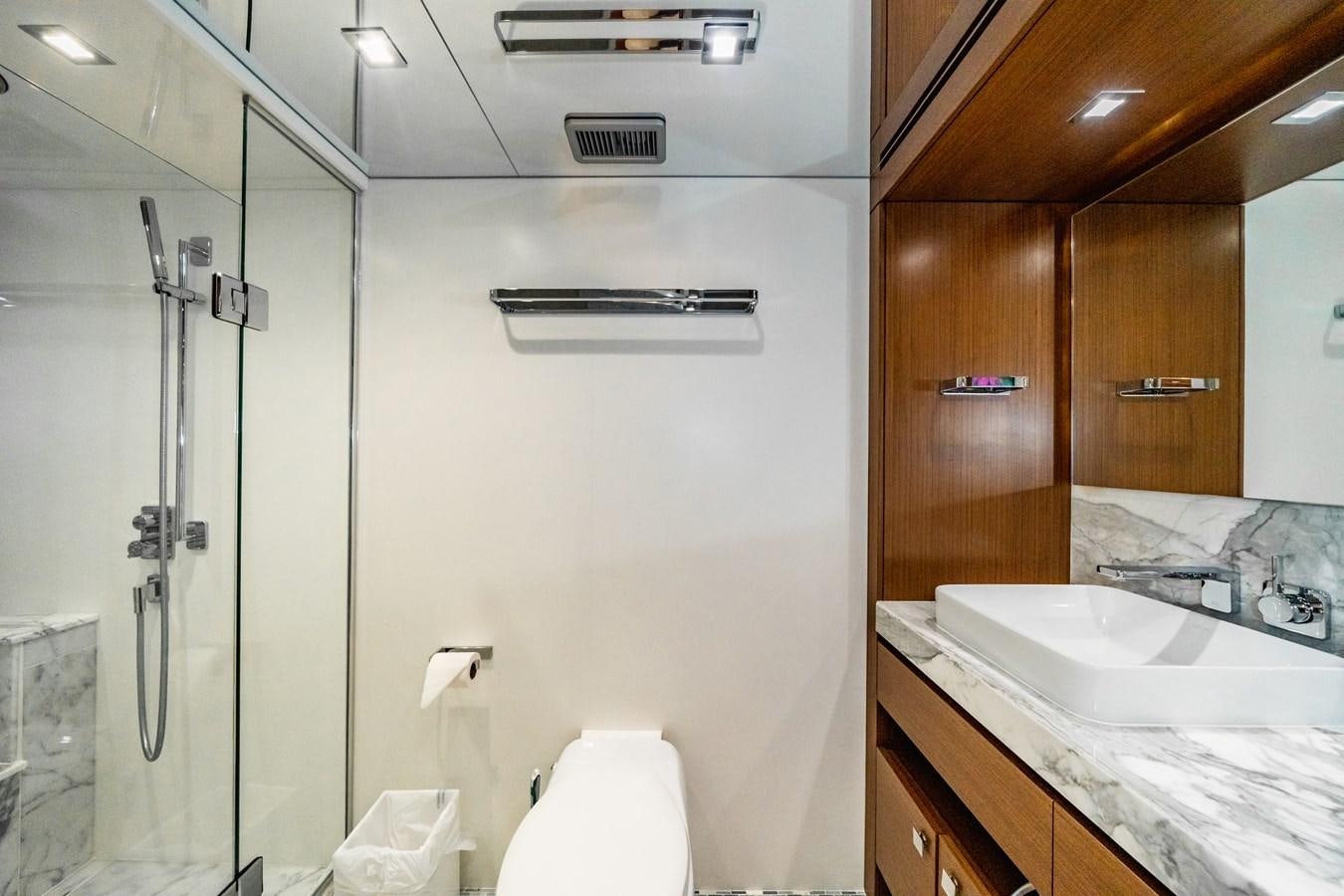 a bathroom with a glass shower aboard 2017 HATTERAS M75 K SEA Yacht for Sale