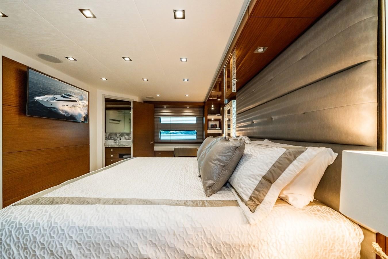 a bed with a white sheet aboard 2017 HATTERAS M75 K SEA Yacht for Sale