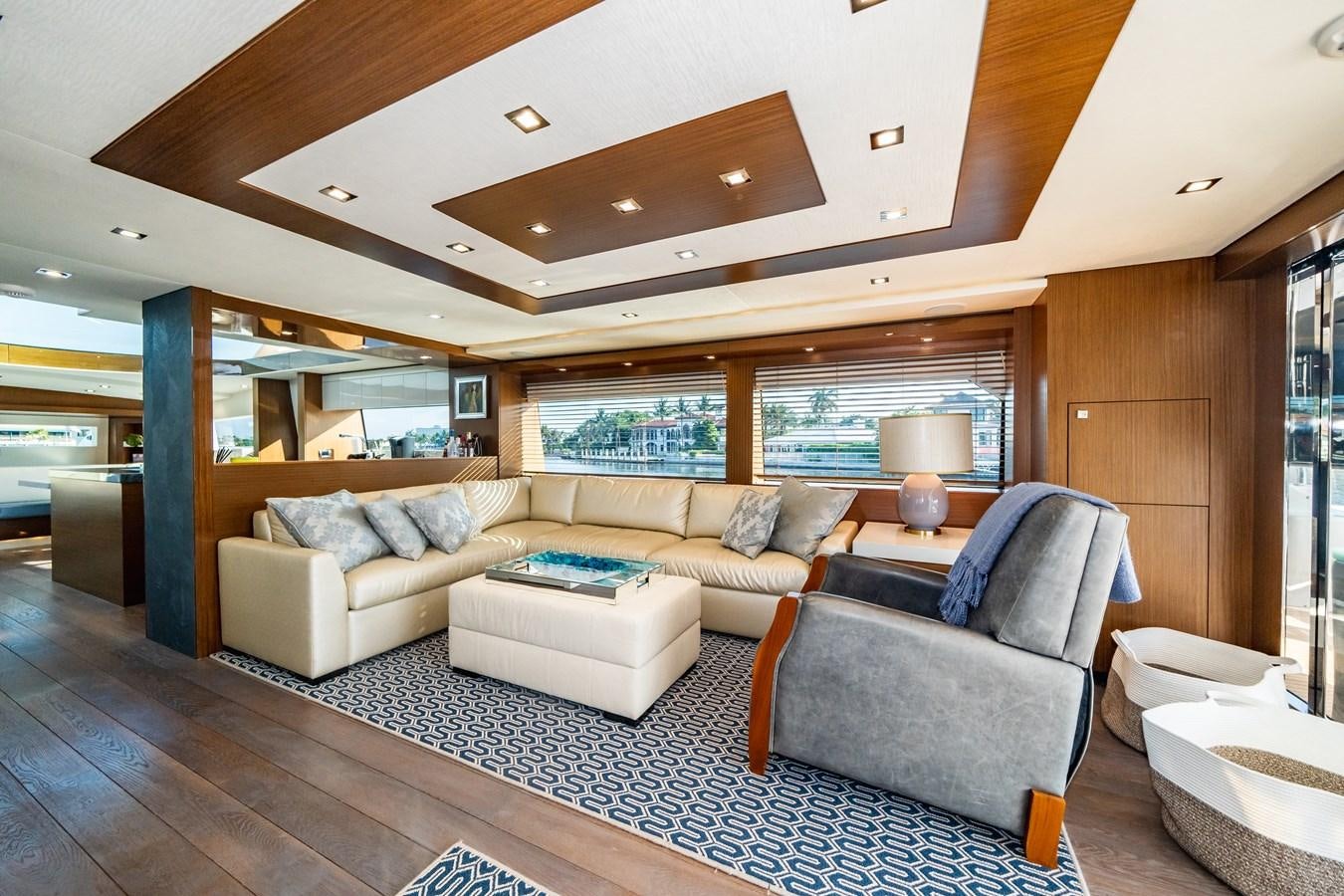 a living room with a large window aboard 2017 HATTERAS M75 K SEA Yacht for Sale