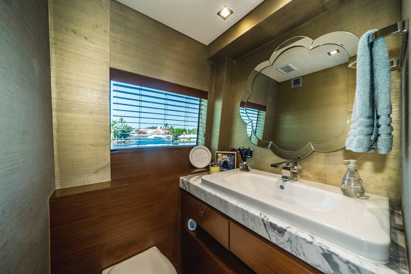 a bathroom with a large mirror aboard 2017 HATTERAS M75 K SEA Yacht for Sale