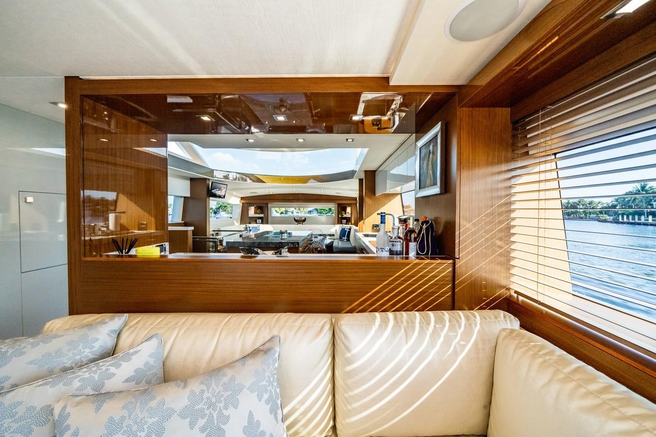 a room with a couch and a window aboard 2017 HATTERAS M75 K SEA Yacht for Sale