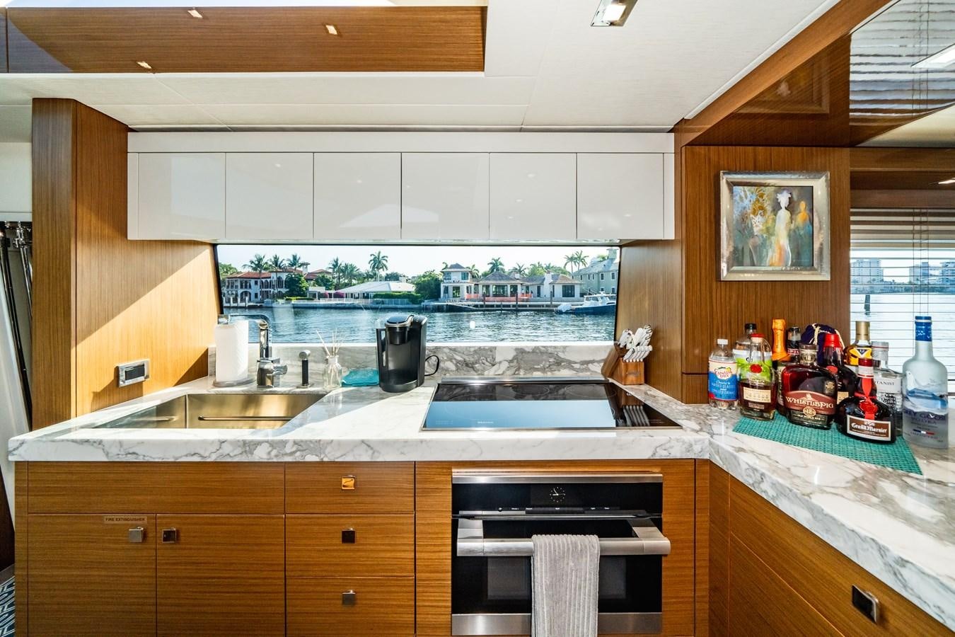 a kitchen with a large window aboard 2017 HATTERAS M75 K SEA Yacht for Sale