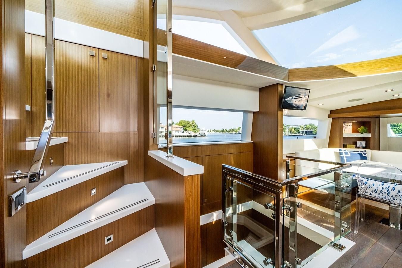 a room with wooden walls and a table and chairs aboard 2017 HATTERAS M75 K SEA Yacht for Sale