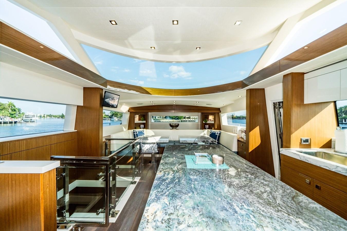 a large open kitchen and dining area aboard 2017 HATTERAS M75 K SEA Yacht for Sale