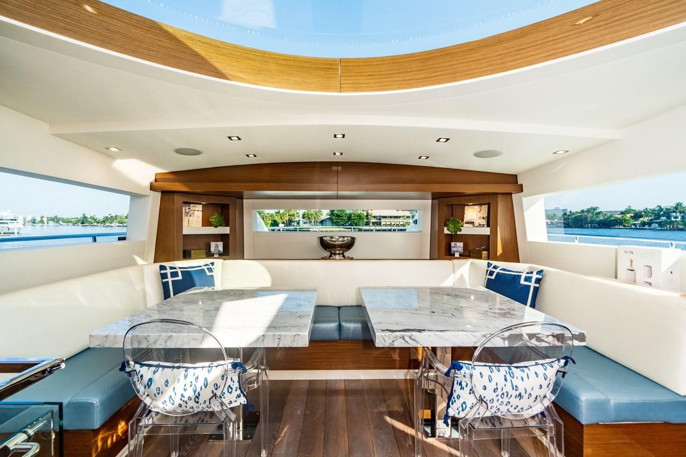 a living room with a large open window aboard 2017 HATTERAS M75 K SEA Yacht for Sale