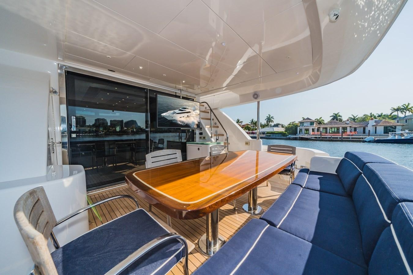 a table and chairs on a boat aboard 2017 HATTERAS M75 K SEA Yacht for Sale